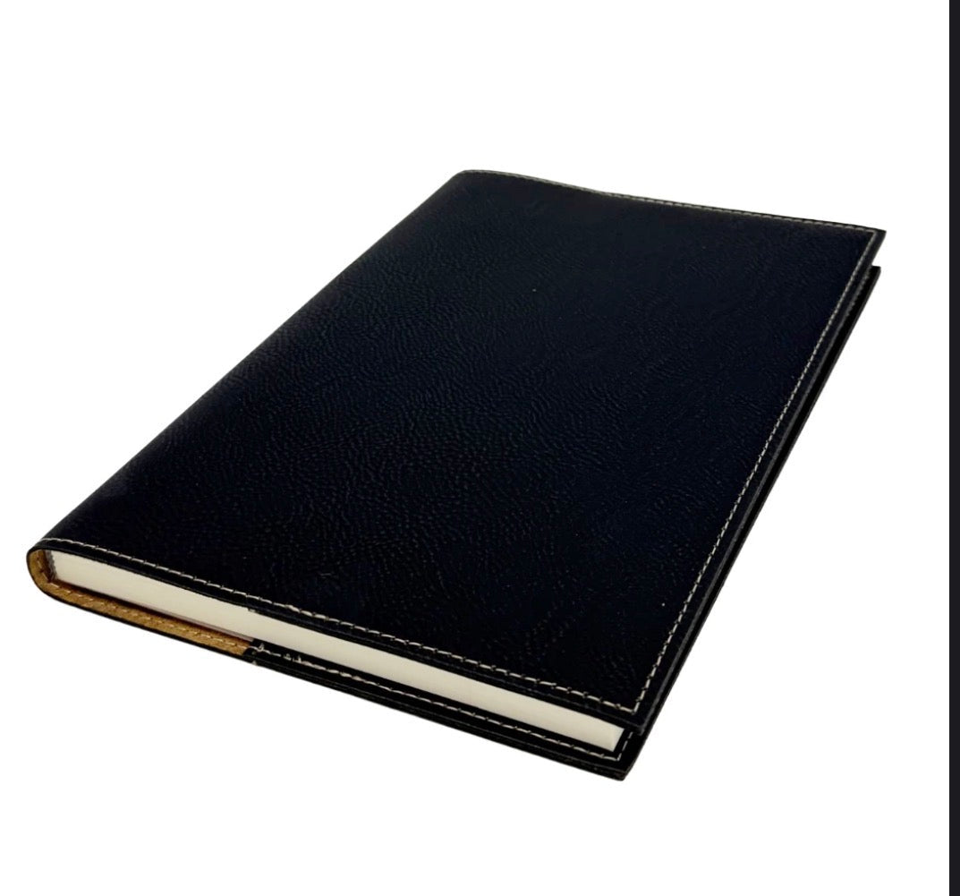 A black textured leather notebook or journal with white stitching and a tan spine, shown at an angle on a white background.