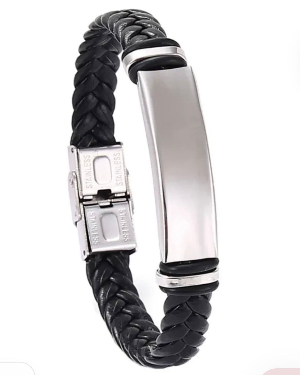 A black braided leather bracelet with a polished silver stainless steel ID plate and clasp, shown on a plain white background.
