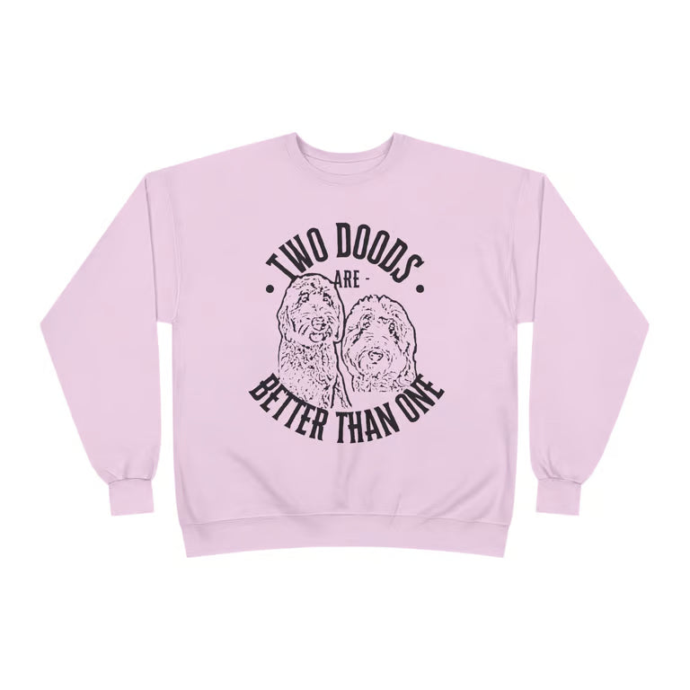 Light pink crewneck sweatshirt featuring the phrase "Two Doods Are Better Than One" with a vintage-style illustration of two doodle dogs. Cozy dog mom sweatshirt for Goldendoodle lovers and multi-dog households