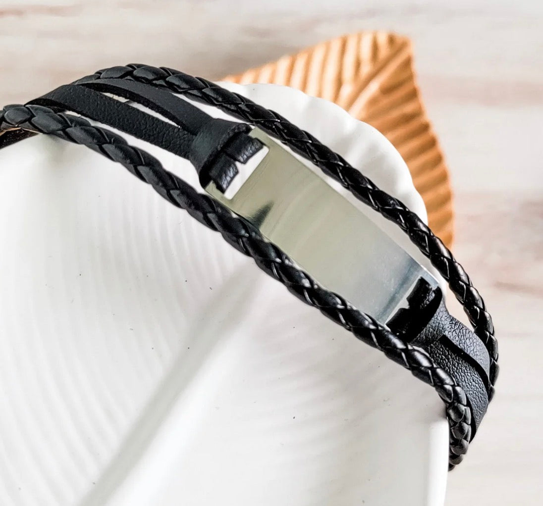 "Triple strand black leather bracelet with mirror-polished stainless steel anchor clasp"
