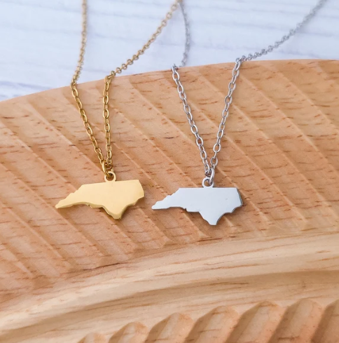 "North Carolina state silhouette pendant necklace in gold and silver mirror-polished stainless steel"
