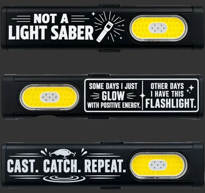 Three black novelty lighters shown vertically on a gray background, each with a different printed slogan or graphic: 'NOT A LIGHT SABER,' 'SOME DAYS I JUST GLOW WITH POSITIVE ENERGY. OTHER DAYS I HAVE THIS FLASHLIGHT.