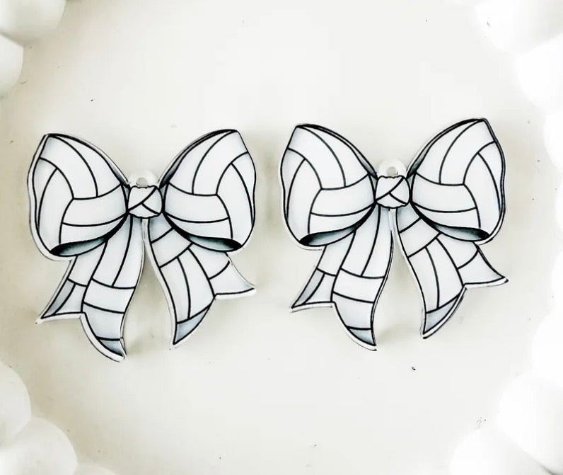 "Volleyball-print acrylic bow earrings with black and white paneling detail, perfect for game day outfits"
