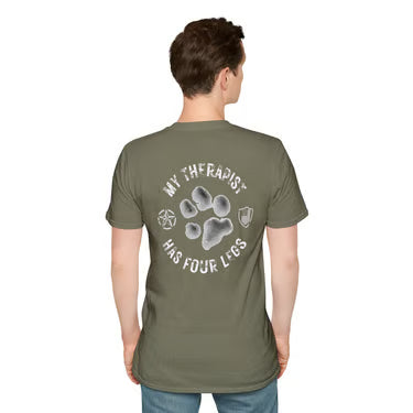 A man viewed from the back wearing an olive green t-shirt with a white graphic print that reads 'MY THERAPIST HAS FOUR LEGS' around a paw print illustration.