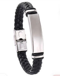 A black braided leather bracelet with a polished silver stainless steel ID plate and clasp, shown on a plain white background.