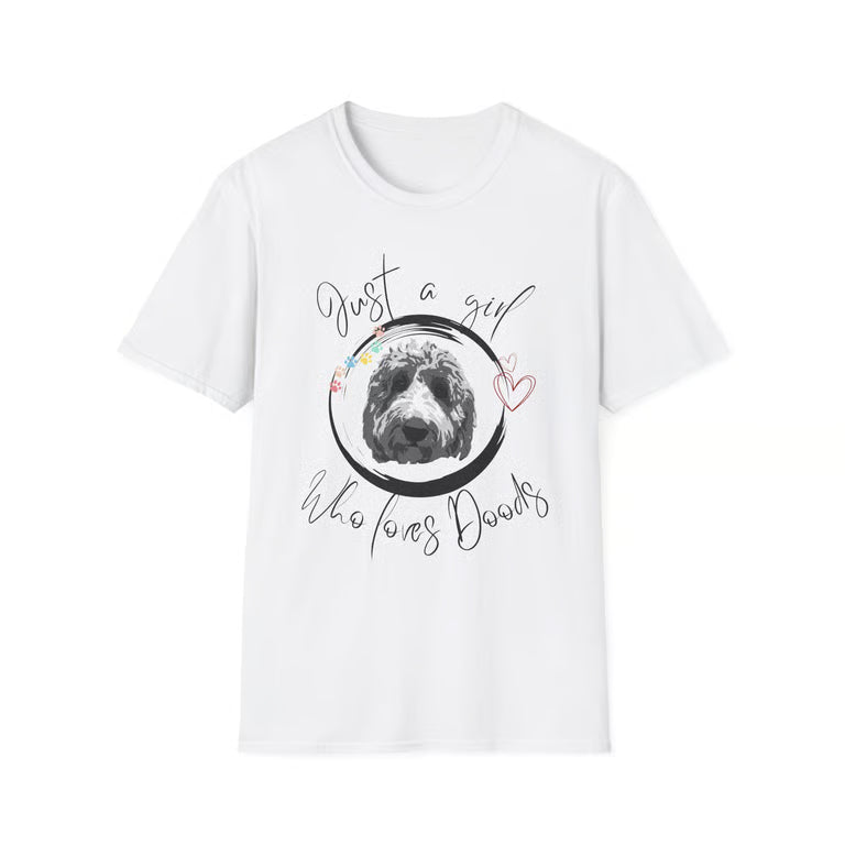 A white short-sleeve crewneck t-shirt featuring a graphic print of a black and white dog inside a circle, surrounded by the text 'Just a girl who loves Dogs' in black script, with a small pink heart on the right side.